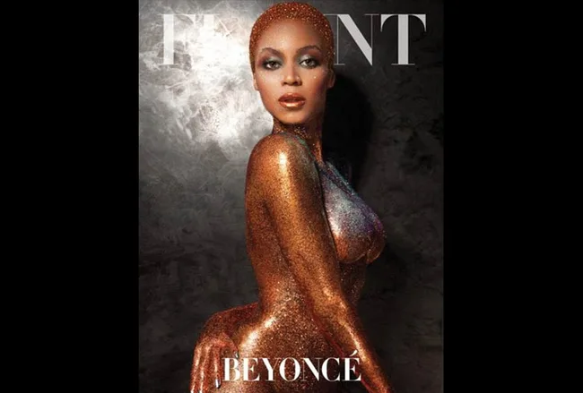 Beyonc&eacute; posing in a glittering gold outfit on the cover of a magazine.