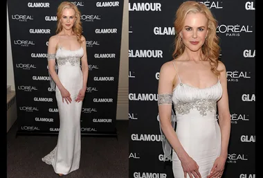 Nicole Kidman in a white embellished gown at a Glamour event, with branded backdrop.