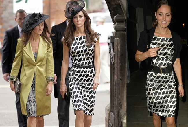 Two women in black and white pattern dresses at event; one wears a yellow coat and hat, the other wears a belt.