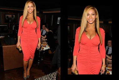 A woman in a form-fitting, bright orange dress at an indoor event, holding a gold clutch, and smiling at the camera.