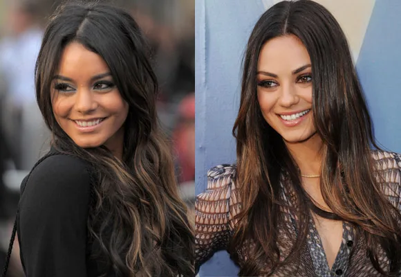 Two women with long dark hair smiling, facing slightly different directions.
