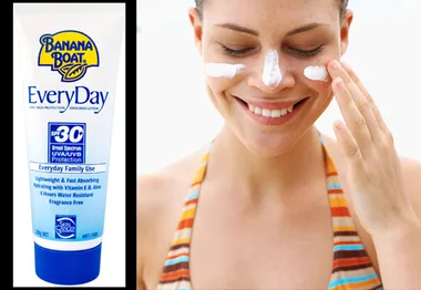 Woman applying Banana Boat sunscreen to her face; bottle with SPF 30 next to her.