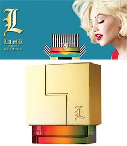 Gwen Stefani's L fragrance bottle with a gold cube design and her photo in the background.