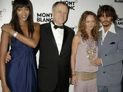 Four people posing together at a Montblanc event; two men in suits and two women in elegant dresses.