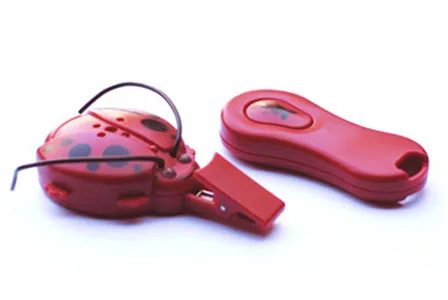 Red ladybug-shaped personal alarm with a keychain remote.