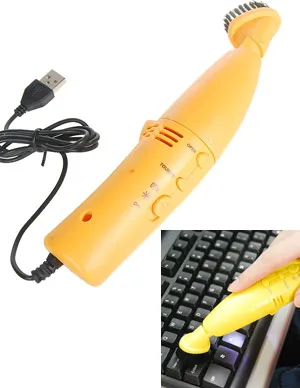 Orange USB mini vacuum cleaner with brush head, shown cleaning a keyboard.