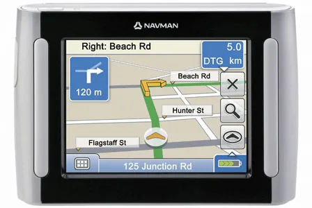 Navman GPS device showing a map with directions to turn right onto Beach Rd in 120 meters.