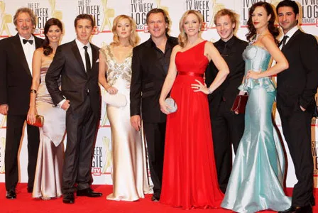Celebrities pose on the red carpet at the 2009 TV Week Logie Awards, dressed in elegant formal attire.