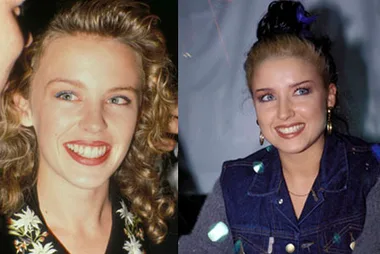 Two women smiling and posing side by side; one with curly hair, the other with dark hair in a denim outfit.