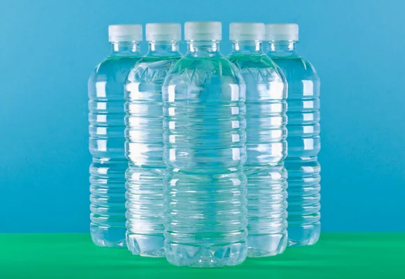 Six clear plastic water bottles on a green and blue background.