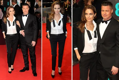 Couple on red carpet in matching black tuxedos at BAFTA event, woman with open collar and untied bowtie.