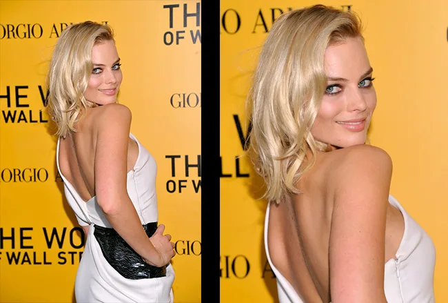Blonde woman in a white dress posing at the "The Wolf of Wall Street" premiere with a yellow backdrop.