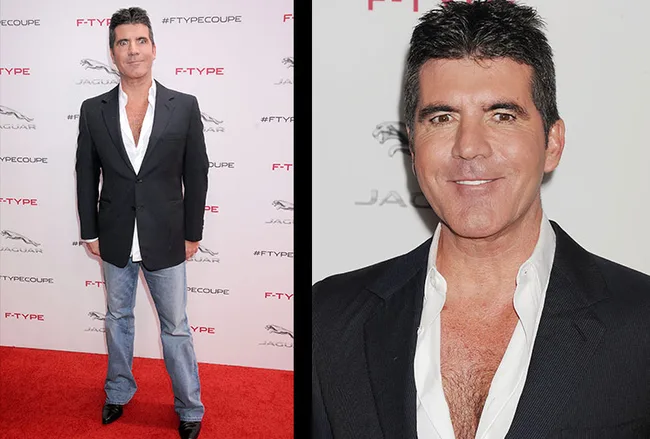 Man in black blazer and jeans on red carpet at Jaguar event, smiling.
