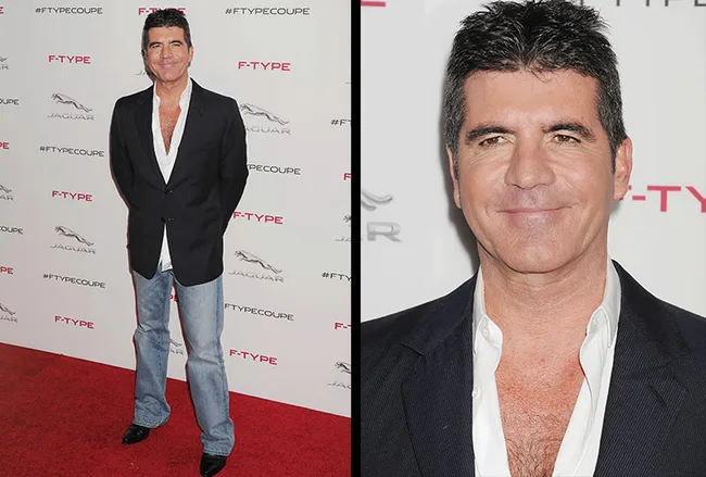 Person in a black blazer and jeans on a red carpet at a Jaguar event backdrop.