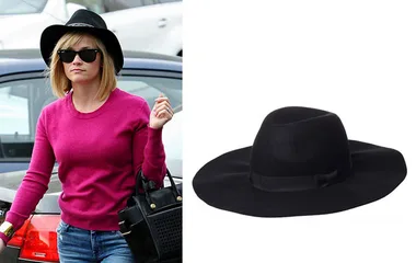 Reese Witherspoon in a pink sweater, black wide-brim hat, sunglasses, holding a black bag; similar hat shown on the right.