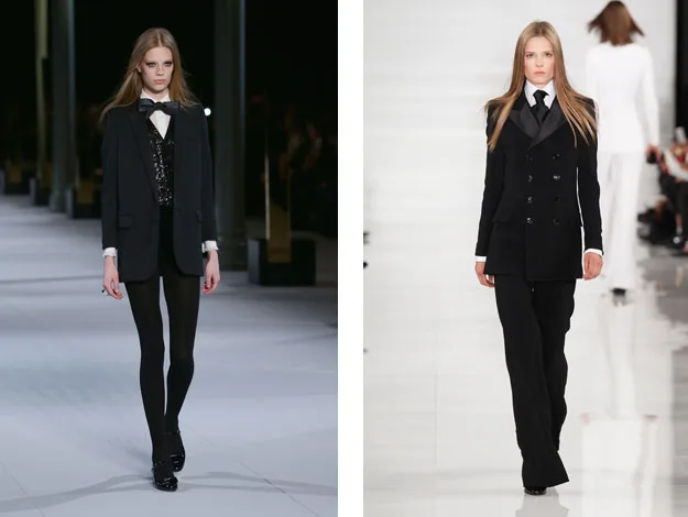 Two models in black tuxedos walk the runway, one wearing trousers and the other in leggings, showcasing formal style.