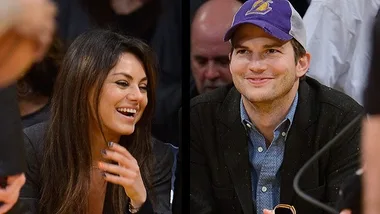 Smiling couple at a basketball game, woman laughing and man wearing a purple cap.