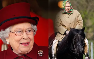Royal figure in red attire smiling and horse riding in the countryside wearing a beige coat and headscarf.