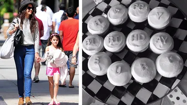 A woman and child walk hand in hand; cupcakes spell "Happy Birthday Suri" on checkered plate.