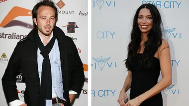 Two individuals at a formal event; the man is in a black jacket and scarf, and the woman in a black dress with long hair.