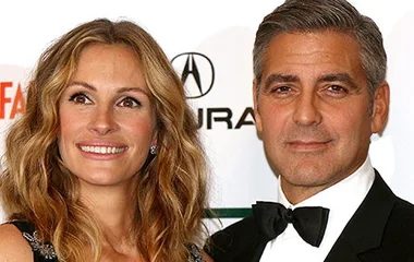 Julia Roberts and co-star at an event, smiling in formal attire.