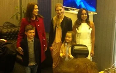 Princess Mary and Jessica Mauboy pose for a photo with two children and another woman in a casual setting.