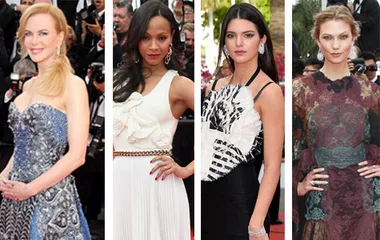 Four women posing on the Cannes 2014 red carpet in elegant dresses, adorned with intricate patterns and embellishments.