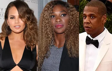Three individuals at a formal event: one in a black dress, one with curly hair in a suit, and one in a white tuxedo.