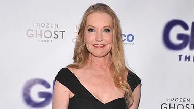 Lisa Niemi in a black dress smiling at a red carpet event.