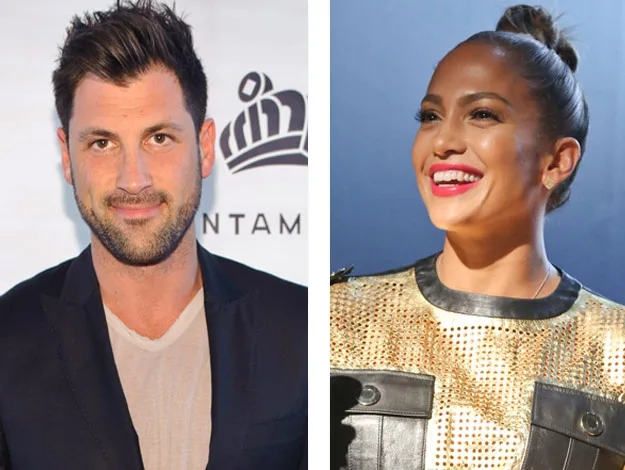 "Two people side by side, one smiling in a suit, the other in a gold outfit, both posing at an event."