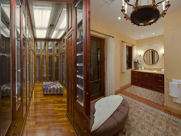 Dressing room with wooden cabinets and ottoman; adjacent bathroom with dual sinks, mirror, and elegant chandelier.