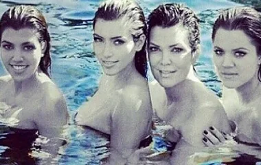 "Four women smiling in a pool, captured in a partially black and white filter."