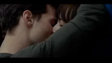 A couple intimately kissing, scene from the Fifty Shades of Grey movie trailer.