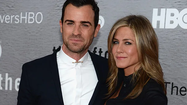 I don't know who these people are, but they're posing together on a red carpet, dressed in formal attire.