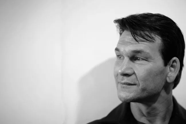 Black and white photo of a man gazing to the right, with short dark hair and a contemplative expression.