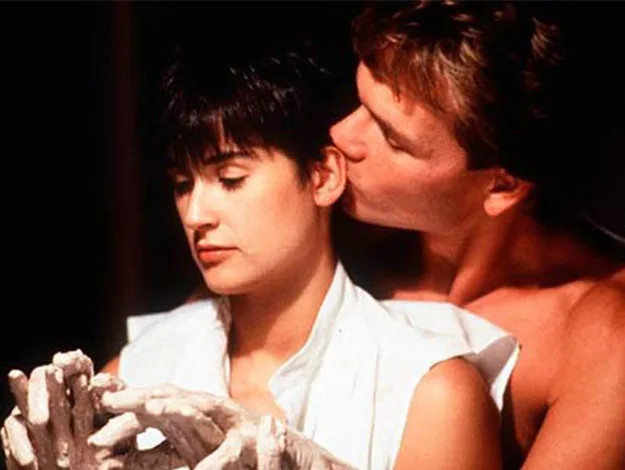 A man kisses a woman&rsquo;s ear as they sculpt clay together, inspired by a scene from the movie "Ghost".