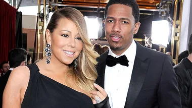 Couple posing in formal attire at a glamorous event.