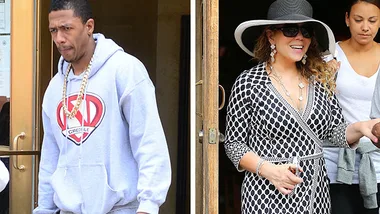 Two people exiting a building: one wearing a hoodie, the other in a polka dot dress and hat.