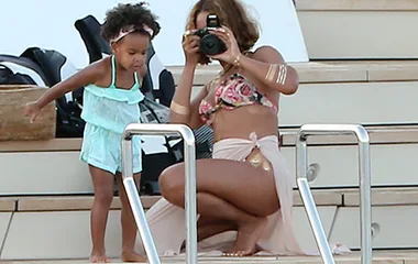 Beyoncé takes a photo of Blue Ivy on a yacht in Italy, both in swimwear enjoying a sunny day.