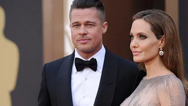 Two individuals in formal attire at a red carpet event.