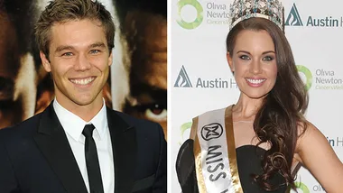 Two people smiling, one in a suit, the other in a crown and sash reading "Miss World Australia."