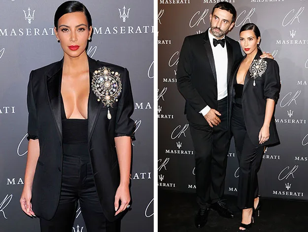 Woman in a black outfit with ornate brooch posing alone and with a man in formal wear at a Maserati event.