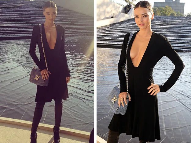 A person in a black dress with a low neckline stands near a water feature, holding a designer bag.