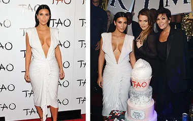 Kim Kardashian in a plunging white gown at a birthday event with a tiered cake and attendees at TAO celebration.