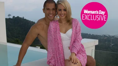 Couple smiling by a pool with scenic view; Woman's Day exclusive.