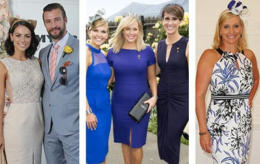 Women and a man dressed elegantly for Melbourne Cup, wearing hats and fascinators.