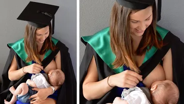 University graduate in cap and gown breastfeeding her baby.