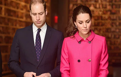 Prince William and Duchess Catherine visiting the 9/11 Memorial, solemnly observing in formal attire.