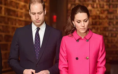 Prince William and Duchess Catherine visiting the 9/11 Memorial, solemnly observing in formal attire.