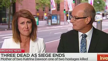 News anchors discussing Sydney siege with visible emotion on screen, headline reads about the tragic event's casualties.